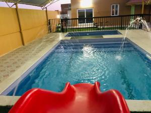 a pool with a water fountain in the middle at Galaxy VIP in Salalah