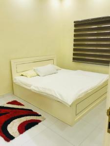 a white bed in a room with a window at Galaxy VIP in Salalah +22 photos