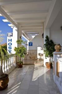 a hallway with potted plants in a building at Hostal Europa in Estepona