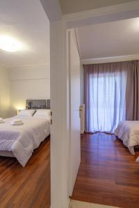 Postel nebo postele na pokoji v ubytování Kleio - Spacious apartment in Glyfada