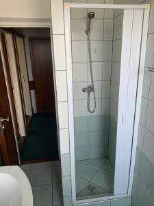 a bathroom with a shower with a glass door at Poľovný dom in Jelšava