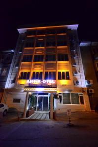 a large building with a lit up facade at night at Antik Otel in Ankara