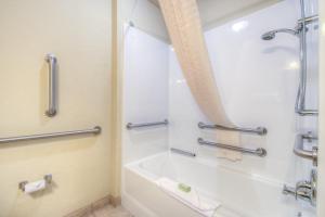 a bathroom with a shower and a tub and a sink at Cobblestone Inn & Suites - Wray in Wray