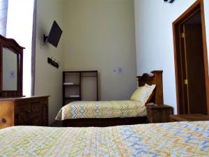 Postel nebo postele na pokoji v ubytování Hotel Purisima Concepción