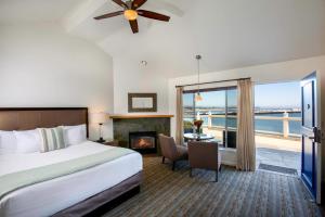 a hotel room with a bed and a tv at Sea & Sand Inn in Santa Cruz