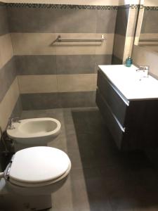 a bathroom with a toilet and a sink at La piscina 2 in Marina di Massa