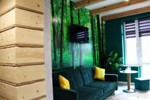 a living room with a green wall at Dworek Zakopane in Zakopane