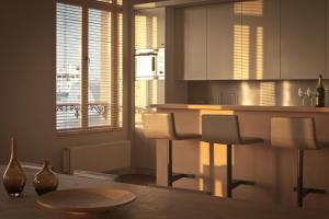 a kitchen with white cabinets and a table with chairs at Loft O - River View in Antwerp +7 photos
