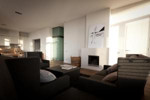 a living room with two couches and a fireplace at Loft O - River View in Antwerp