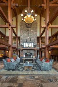 a large living room with couches and a stone fireplace at Lodges at Deer Valley in Park City