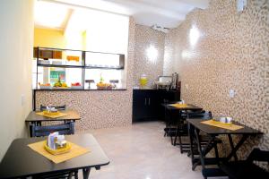 a dining room with tables and chairs in a restaurant at Hotel Hot Brás in São Paulo
