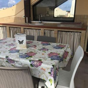 a table and chairs with a table and a sink at ULISSE in San Vito lo Capo