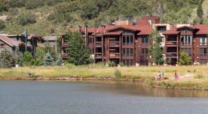 a large building next to a body of water at Silver Baron Lodge in Park City