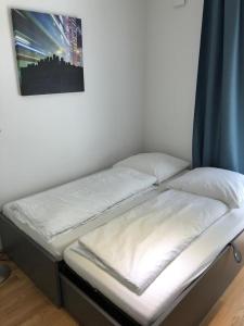 a bed in a room with a picture on the wall at My room serviced apartment-Messe in Munich