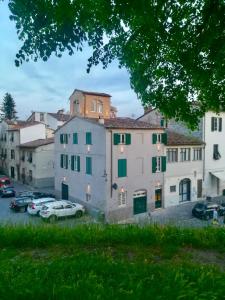 a group of buildings with cars parked in a parking lot at Inside the Wall in Lucca