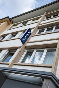 a blue sign on the side of a building at Key Inn Appart Hotel Parc de Merl in Luxembourg