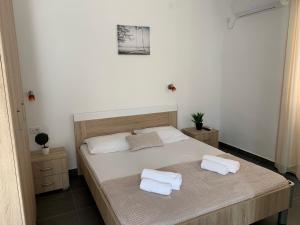 a bedroom with a bed with two towels on it at Guesthouse Orlović in Budva