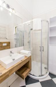 a bathroom with a sink and a shower at Smart Rental Management Aleksandr Hercen Apartment in Wrocław