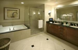 a bathroom with a tub and a shower and a sink at The Signature at MGM Grand - All Suites in Las Vegas