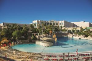 a large swimming pool at a resort with buildings in the background at Mandalay Bay in Las Vegas