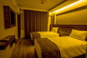 Postel nebo postele na pokoji v ubytování Fidanoglu Suite Hotel