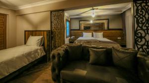 Postel nebo postele na pokoji v ubytování Fidanoglu Suite Hotel