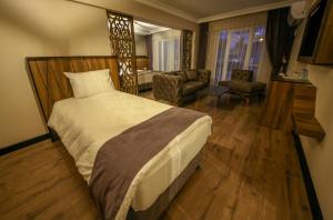 Postel nebo postele na pokoji v ubytování Fidanoglu Suite Hotel
