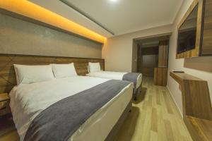 Postel nebo postele na pokoji v ubytování Fidanoglu Suite Hotel