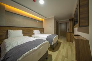 Postel nebo postele na pokoji v ubytování Fidanoglu Suite Hotel