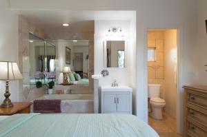 a bathroom with a bed and a tub and a sink at Casa Del Sol in Carpinteria