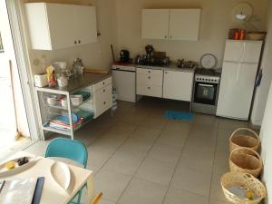 a kitchen with white cabinets and a white floor at Six-bedroom House With Terrace Ionian Sea View in Neokhórion