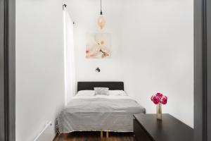 a bedroom with a bed and a lamp at Karma Boutique Apartments in Budapest