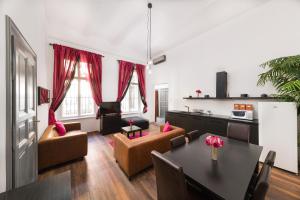 a living room filled with furniture and a tv at Karma Boutique Apartments in Budapest