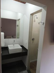 a bathroom with a sink and a mirror at Flat Camburi in Camburi