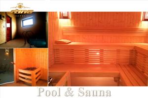 a wooden sauna with a bench in a room at Sting Hotel & Event Palace in Velikaya Dobronʼ