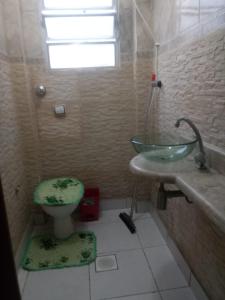 a bathroom with a sink and a toilet at Apartamento Temporada in São Vicente +49 photos