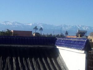 a view of the mountains from the roof of a building at Dar Margot Marrakech in Marrakesh