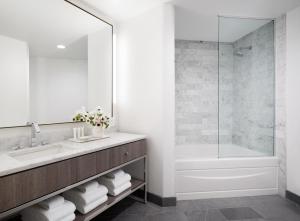 a bathroom with a sink and a shower at AKA Beverly Hills in Los Angeles