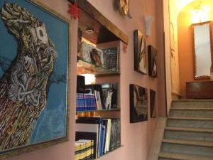 a hallway with a painting of a woman on a wall at B&B Domus Dei Cocchieri in Palermo