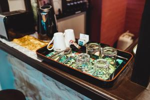 a tray of glasses and cups on a table at Serenity in Sutherland