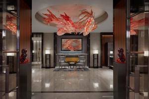 a lobby with a chandelier and a table and chairs at Mandarin Oriental Wangfujing, Beijing in Beijing
