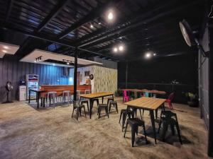 a group of tables and chairs in a room at Bakawan Hostel in Coron