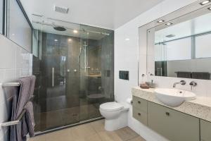 a bathroom with a shower and a toilet and a sink at City Sanctuary on Kilmore in Christchurch +13 photos