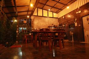 a dining room with wooden chairs and a table at Raven Blue in Ko Lanta