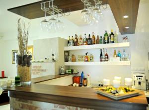 a kitchen with a bar with bottles on shelves at Vila Polar in Štrbské Pleso