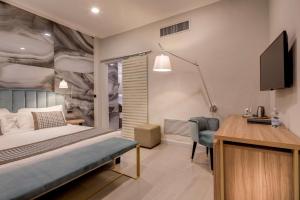 a bedroom with a bed and a desk and a television at Best Western Plus Royal Superga Hotel in Cuneo +111 photos