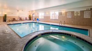 a large swimming pool in a hotel room at Best Western Plus Seminole Hotel & Suites in Seminole