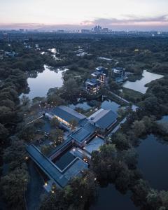 an aerial view of a building on the water at MUH SHOOU XIXI HOTEL HANGZHOU in Yuhang