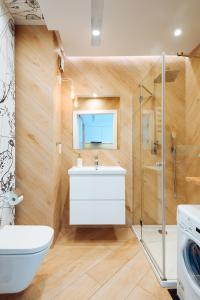 een badkamer met een toilet, een wastafel en een douche bij Apartament Scandi - Bliżej Morza in Kołobrzeg