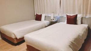 Postel nebo postele na pokoji v ubytování Sakura Terrace